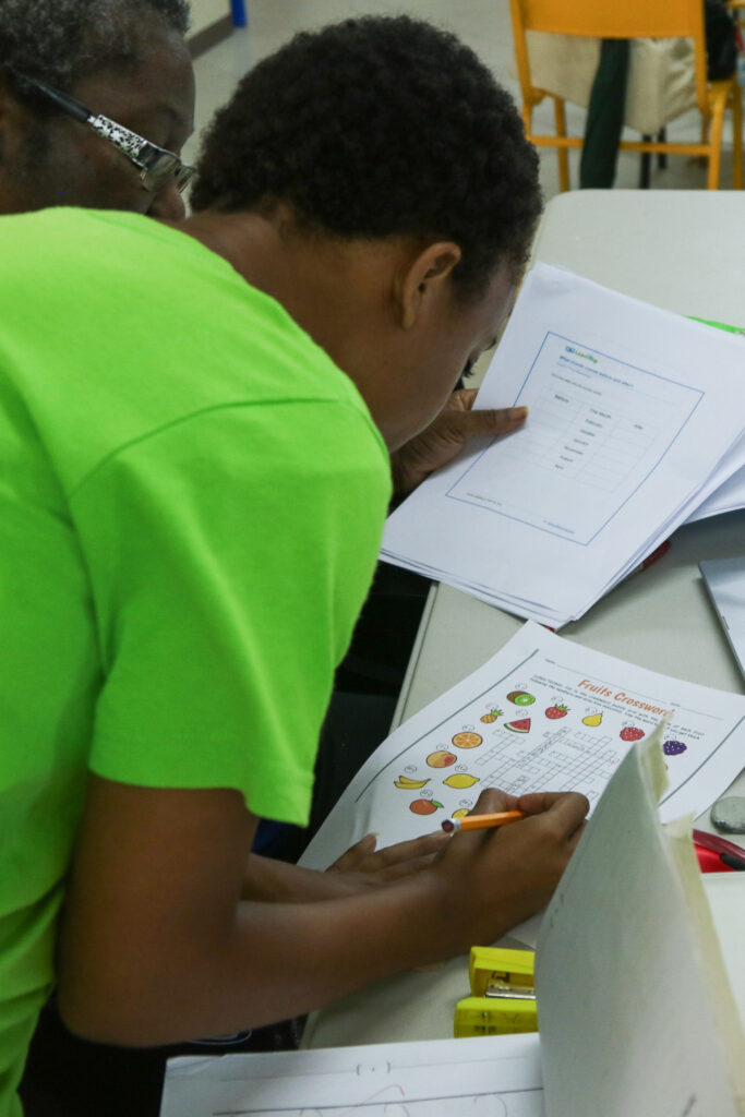 student doing fruit crossword